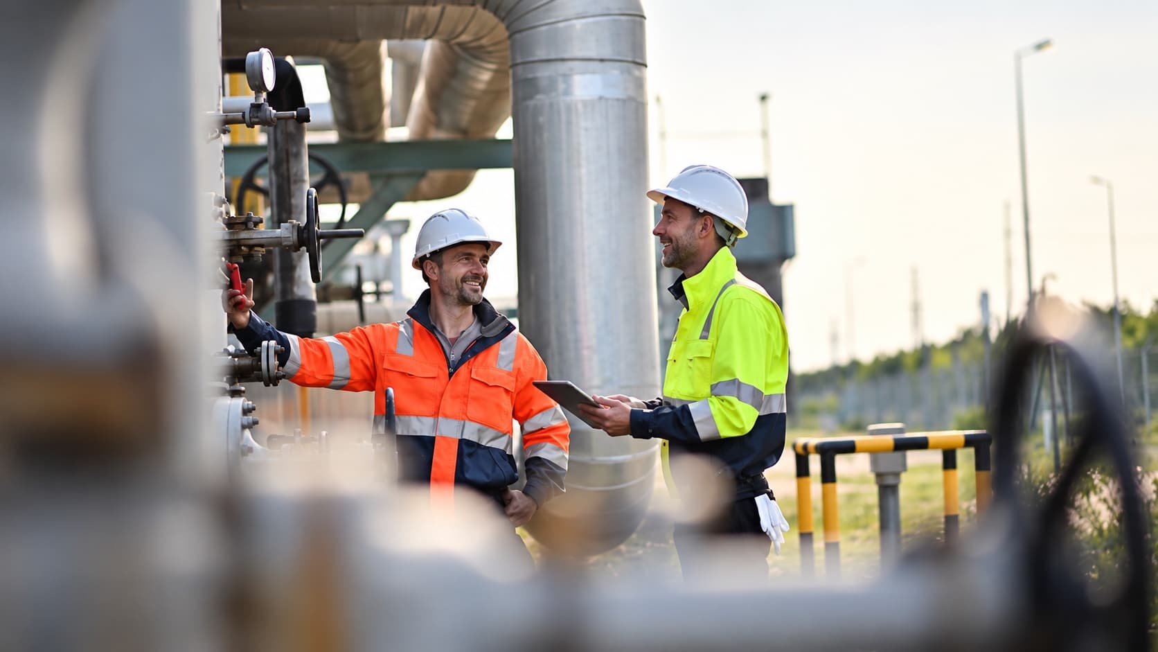 Construction team coordinating site work using a tablet during the construction phase