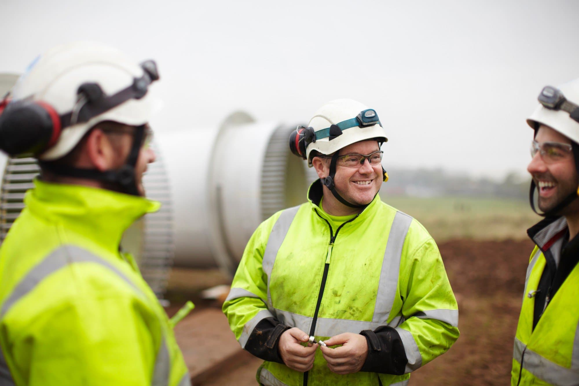 Construction workers discussing site arrangements during a site induction briefing