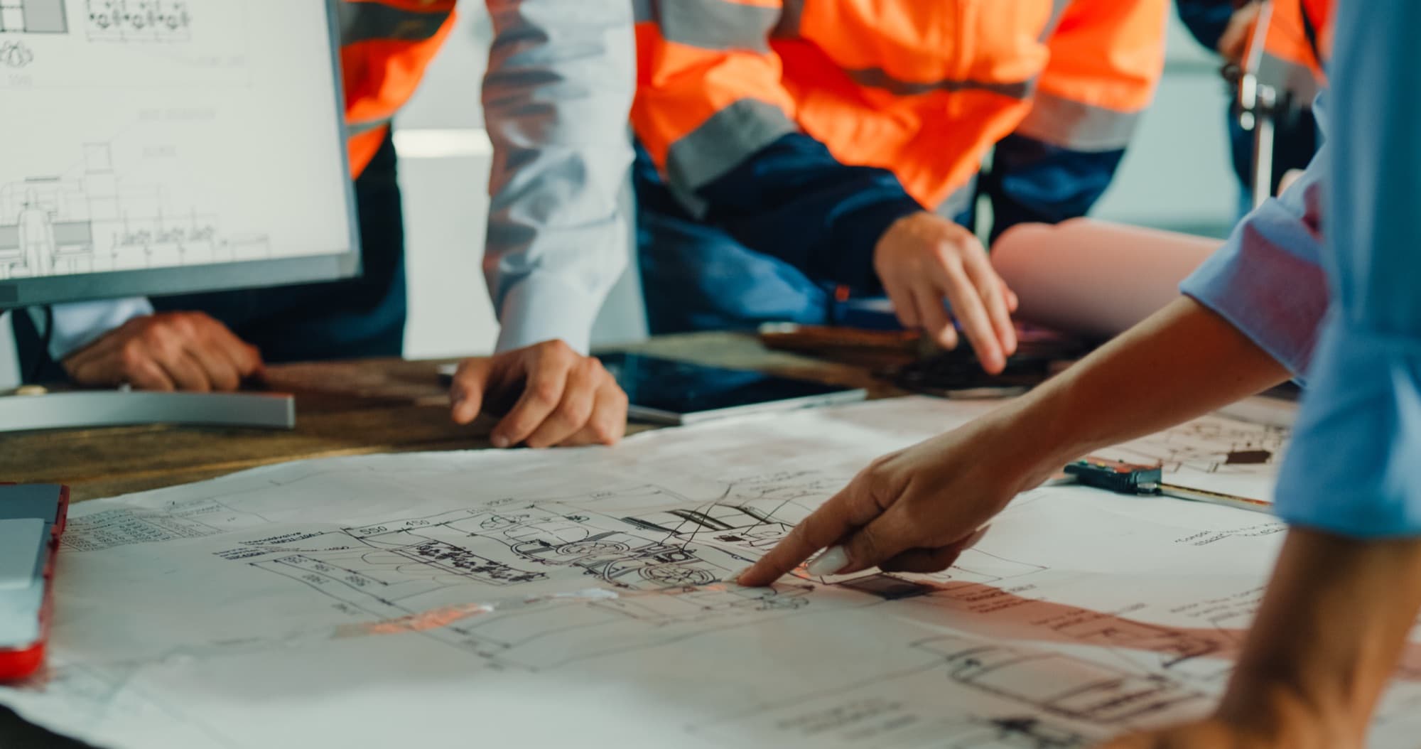 Design team reviewing construction drawings during pre-construction planning